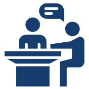 Two people having a conversation at table.